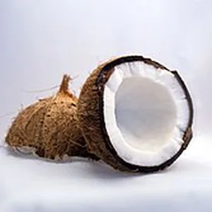 A coconut split open, white flesh in the shell